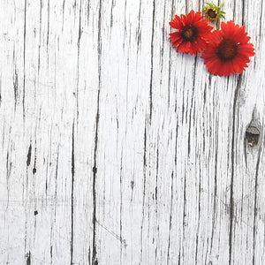 red flowers on wooden background